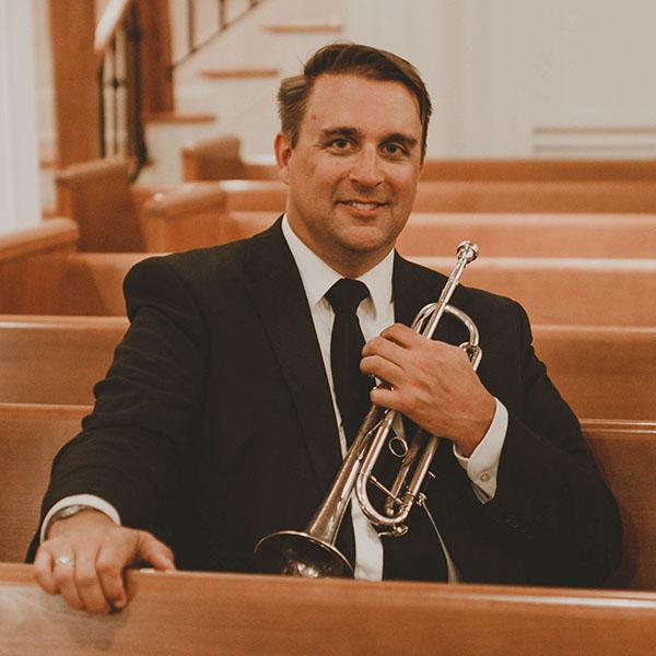 Wayne Bennet holding a trumpet